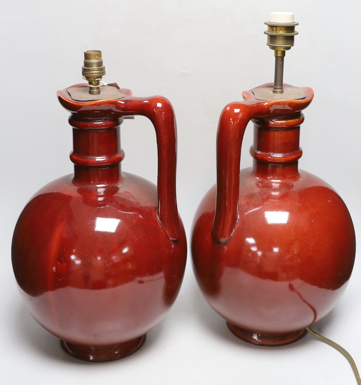 A pair of French wine flasks, converted to lamps, 40cm high